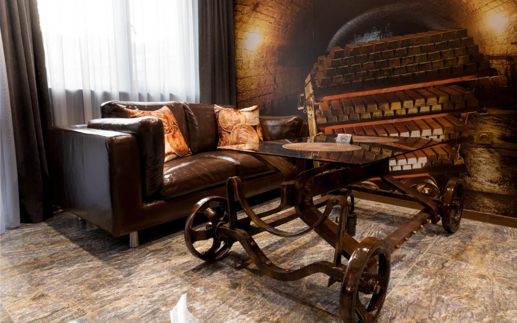 a leather couch and a table in a room at HIDDEN BANK: Digger's Dream in Plovdiv