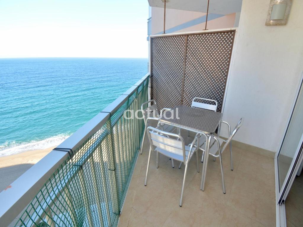 a balcony with a table and chairs and the ocean at CANNES 11-6 in Platja d'Aro