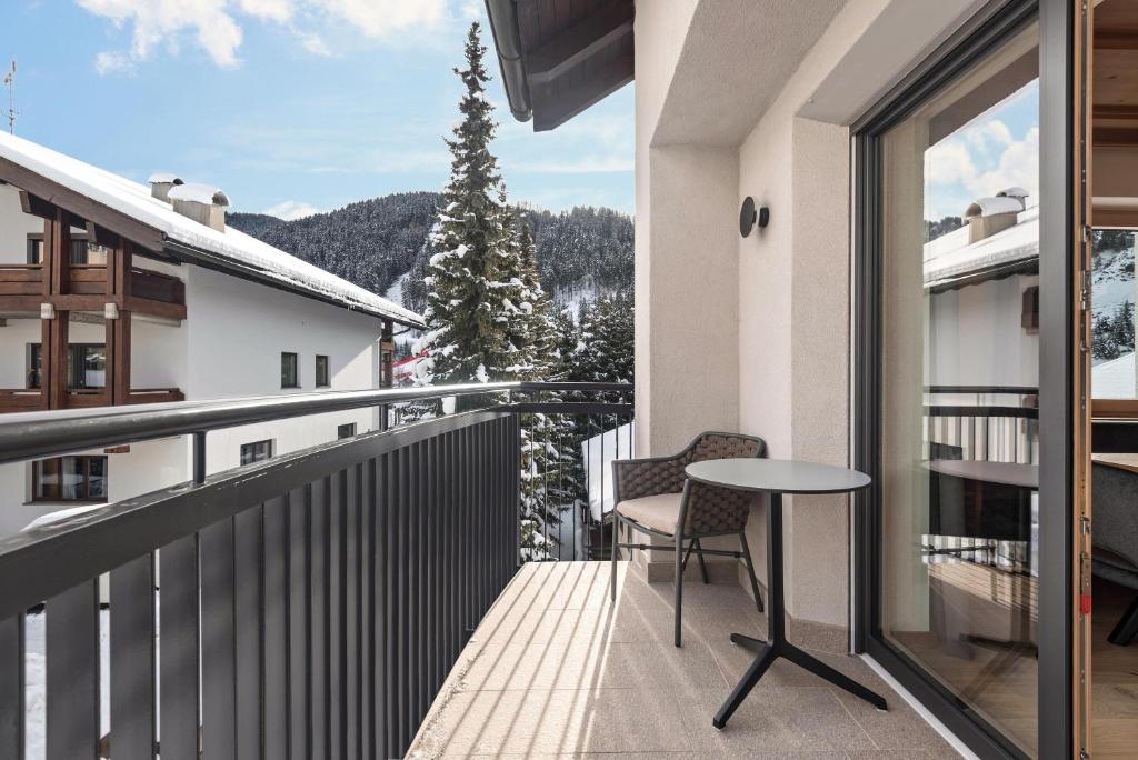 a balcony with a table and a view of a mountain at La Grambla App Sella 1 in Santa Cristina in Val Gardena