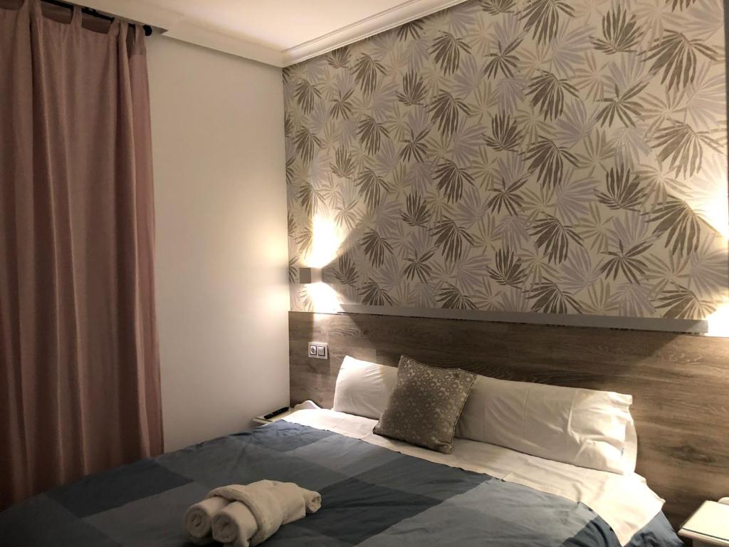 Postel nebo postele na pokoji v ubytování Hostal Alfaro