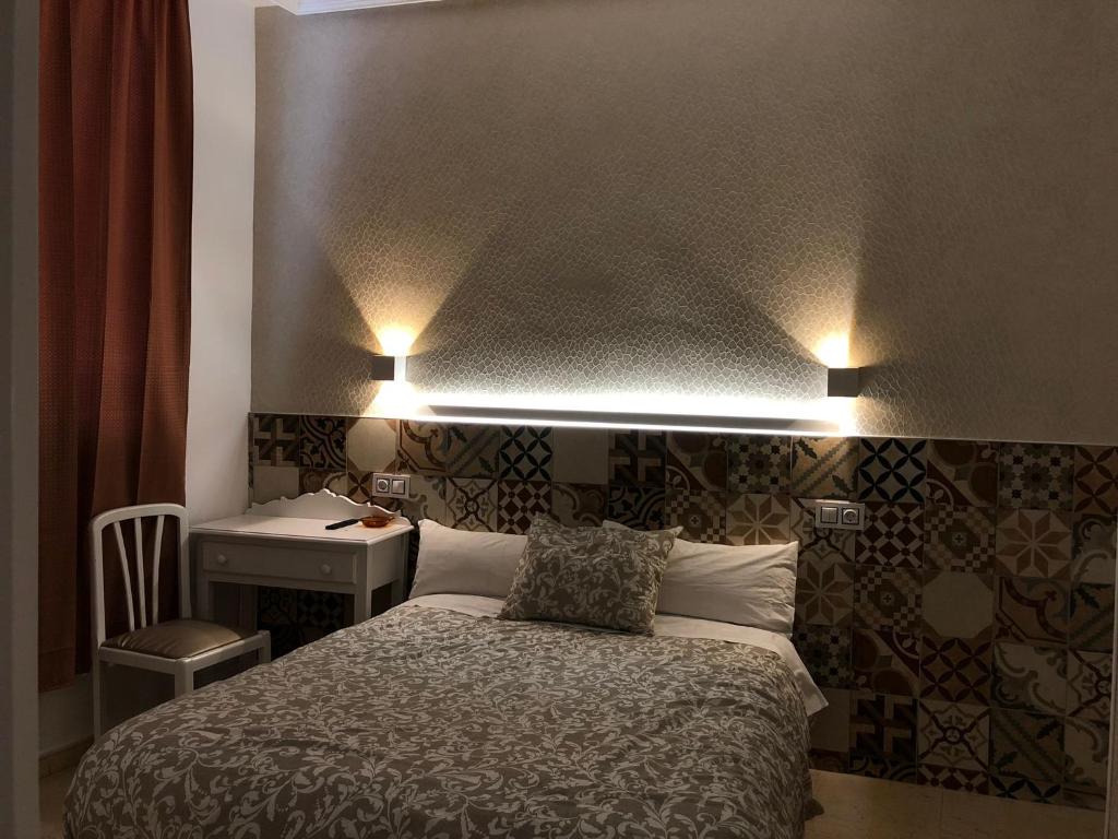 Postel nebo postele na pokoji v ubytování Hostal Alfaro