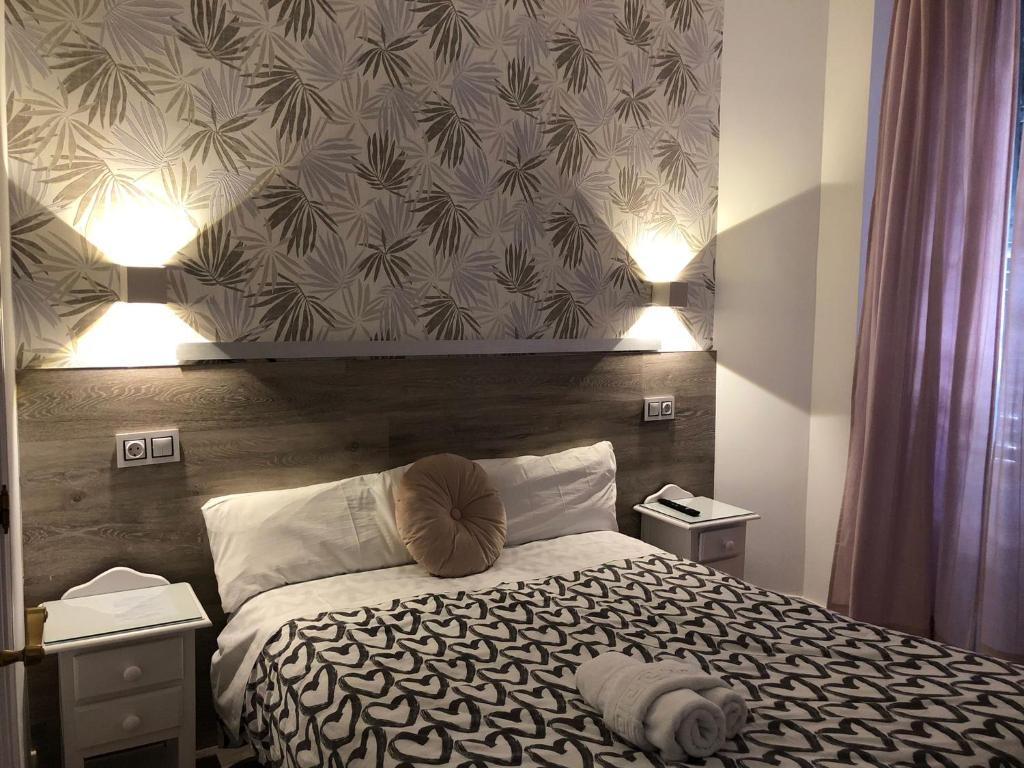 Postel nebo postele na pokoji v ubytování Hostal Alfaro