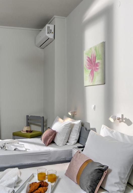 A bed or beds in a room at Asterion Hotel