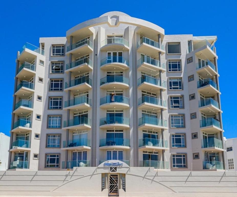 a tall apartment building on the beach at Cascades Self-Catering Apartments in Summerstrand