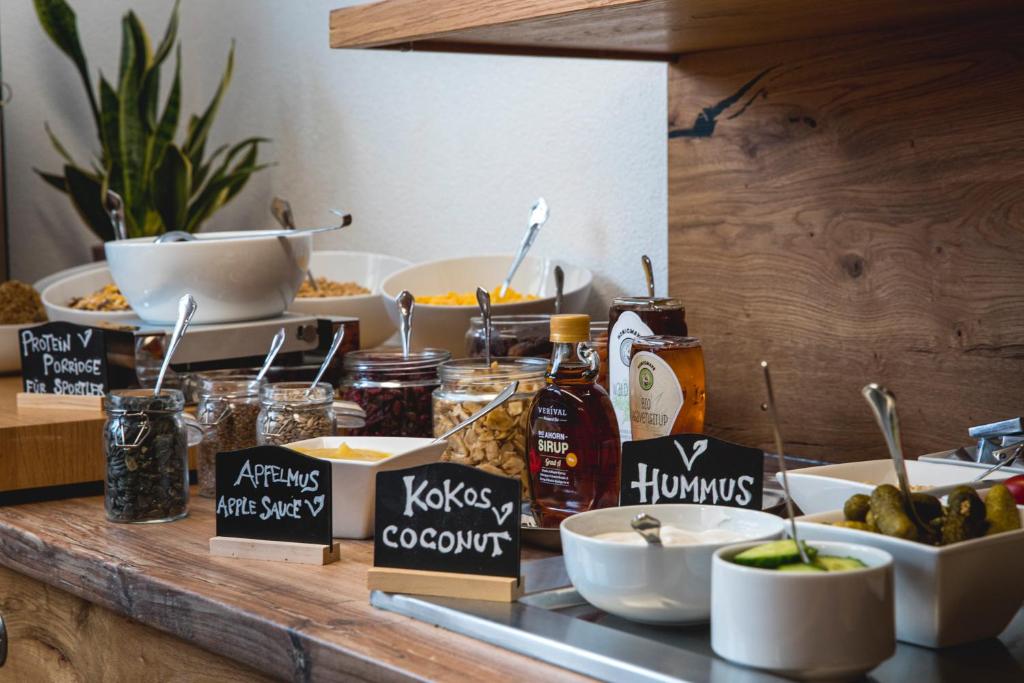 a buffet with food on a wooden counter top at Hotel Montfort in Sankt Anton am Arlberg