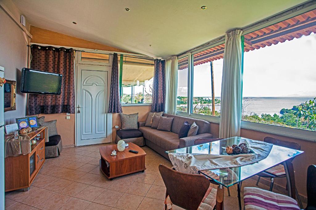 a living room with a couch and a table at Voula Home in Marathi