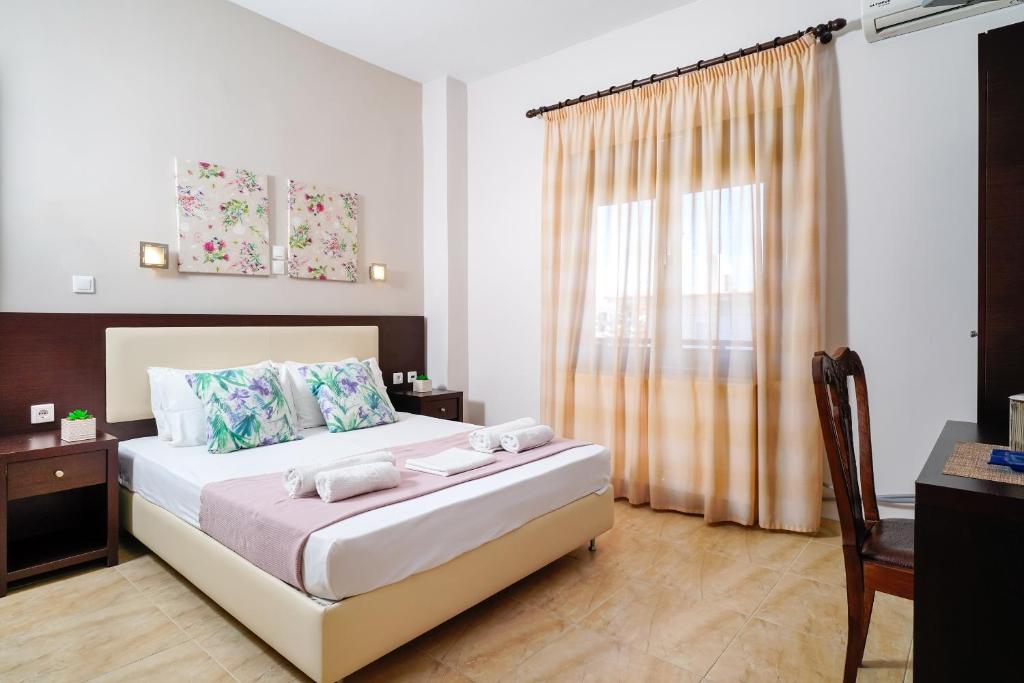 a bedroom with a large bed and a window at Villa Yanna in Olympiada