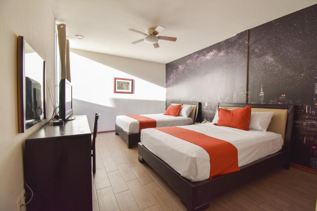 Voodi või voodid majutusasutuse Hotel TÖTEM Guadalajara toas