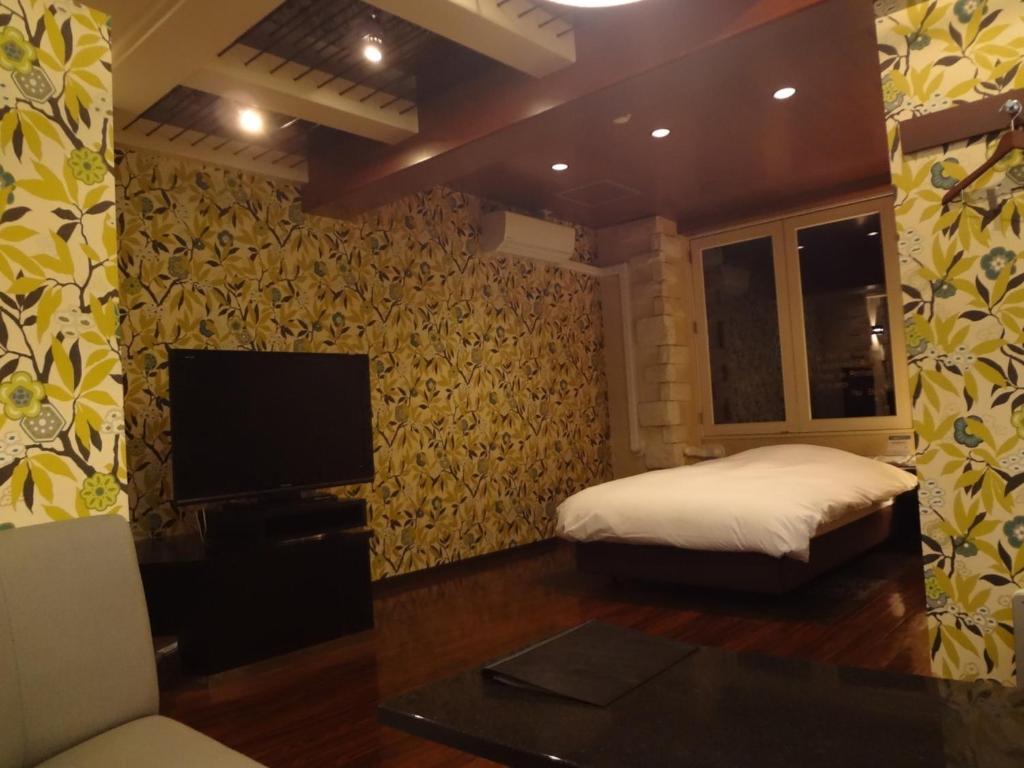 Un pat sau paturi într-o cameră la Royal Hotel Uohachi Bettei - Vacation STAY 27286v
