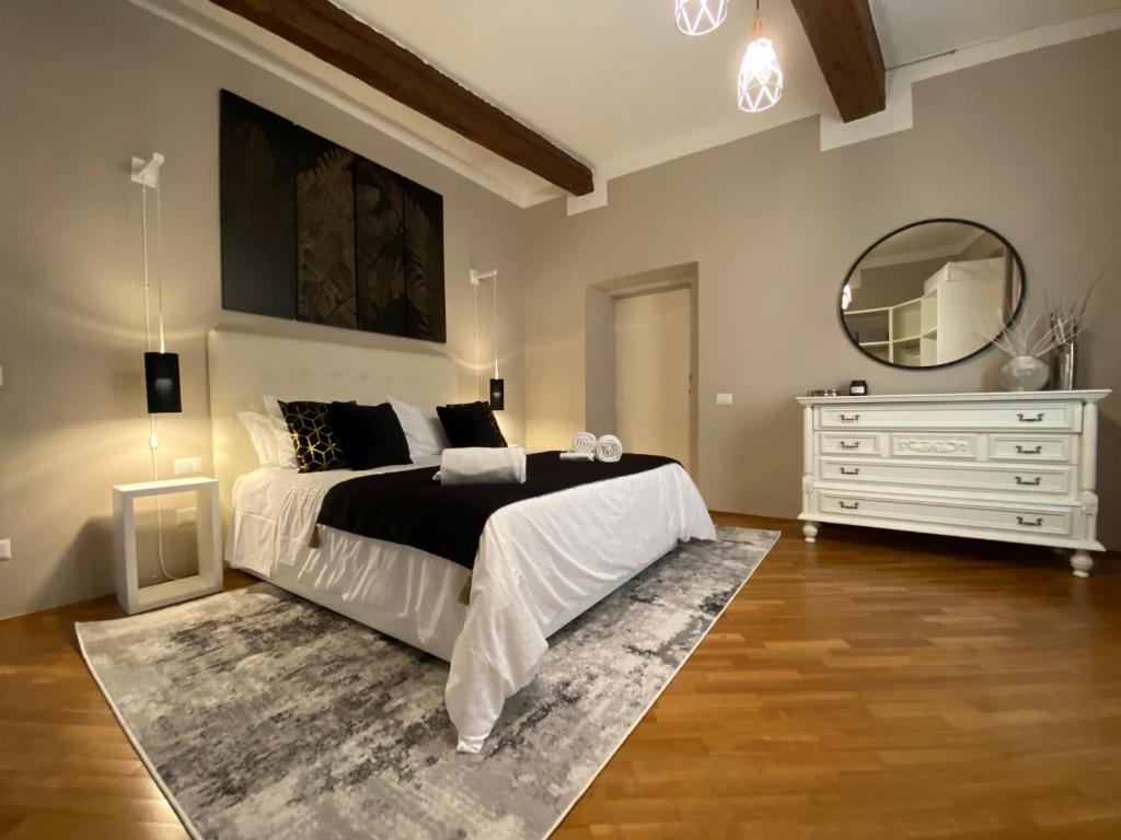 a bedroom with a bed and a dresser and a mirror at The View Of Sangiorgio in Florence