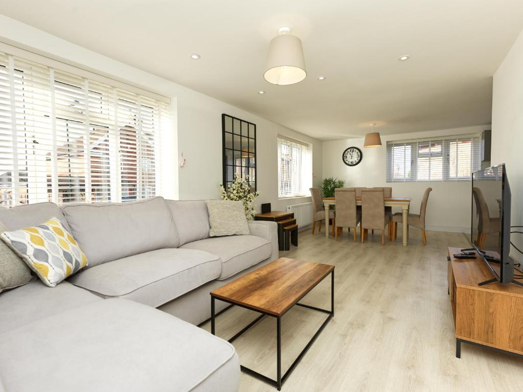 a living room with a couch and a table at Shrewsbury Townhouse with Parking in Harlescott