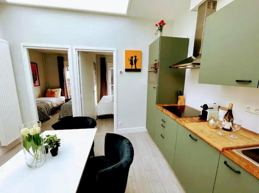 a kitchen with green cabinets and a white counter top at Best Location in Centrum in Leiden