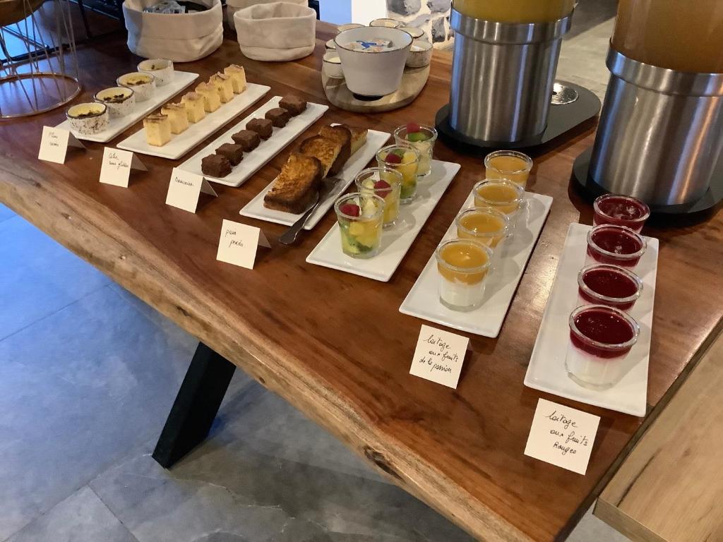a table with many different types of pastries and desserts at Ferme Delgueule in Tournai