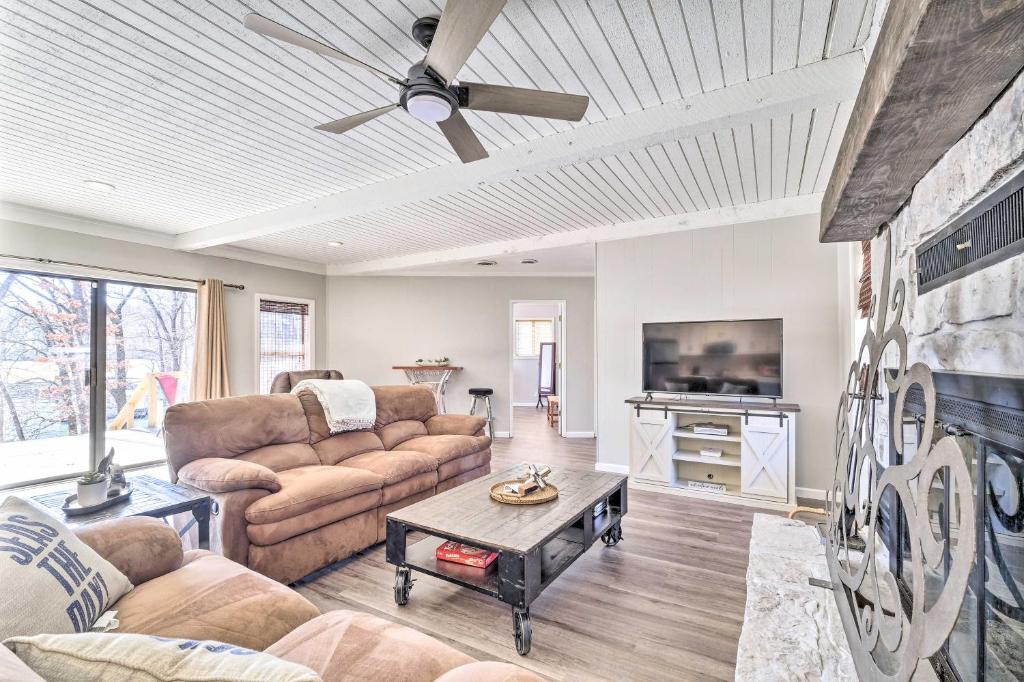 a living room with a couch and a tv at Updated Afton Cottage with Dock and Lake Access! in Afton