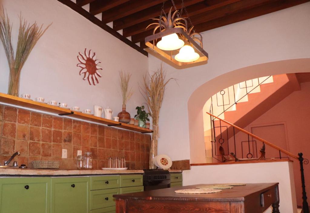 a kitchen with a sink and a table in a room at CASA DAMIANA in Lagos de Moreno