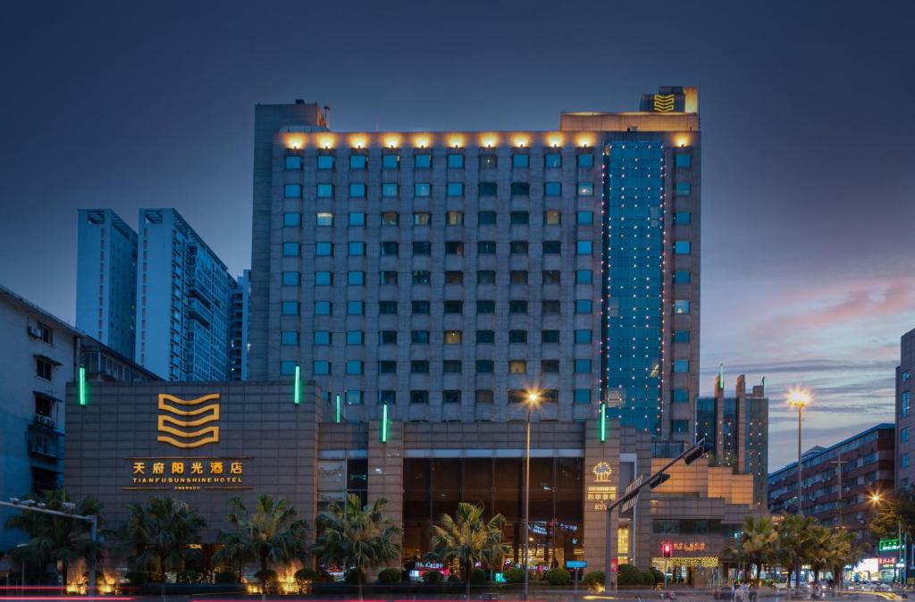 a large building with lights on it in a city at Chengdu Tianfu Sunshine Hotel in Chengdu