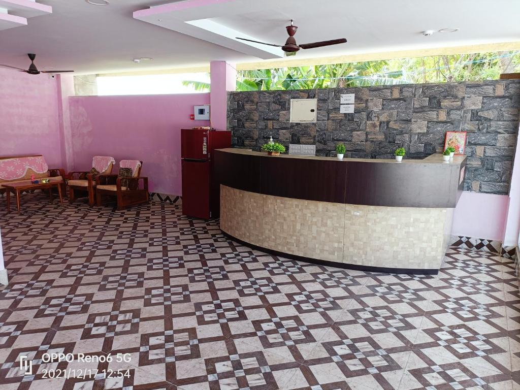 a lobby with a reception counter and a restaurant at HOTEL ANISH in Havelock Island