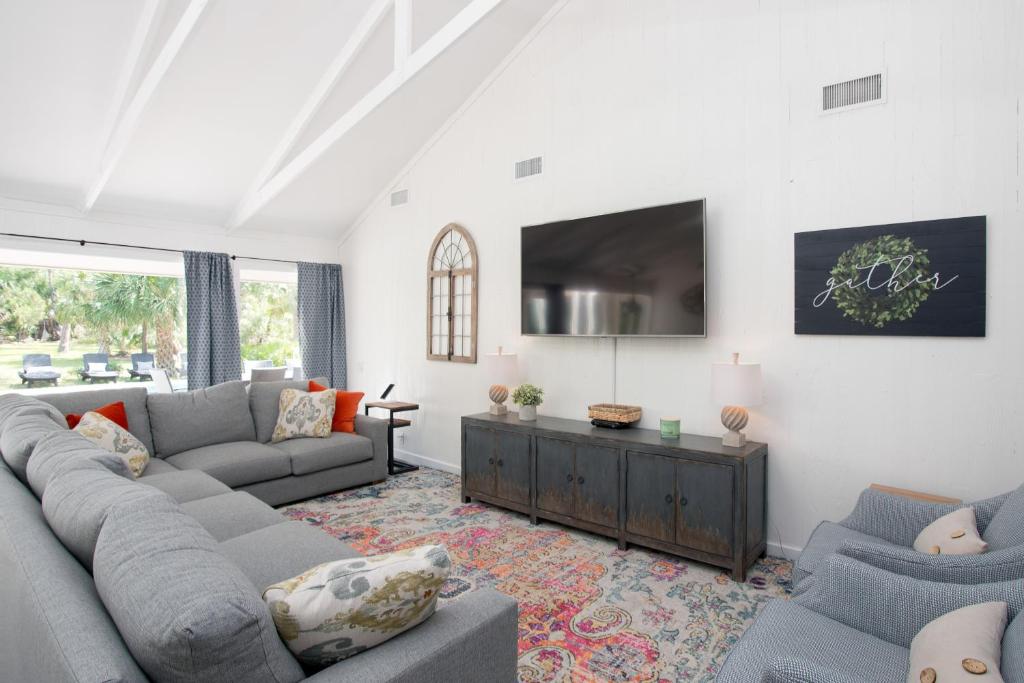 a living room with a couch and a tv at Audubon Pond 22 in Hilton Head Island