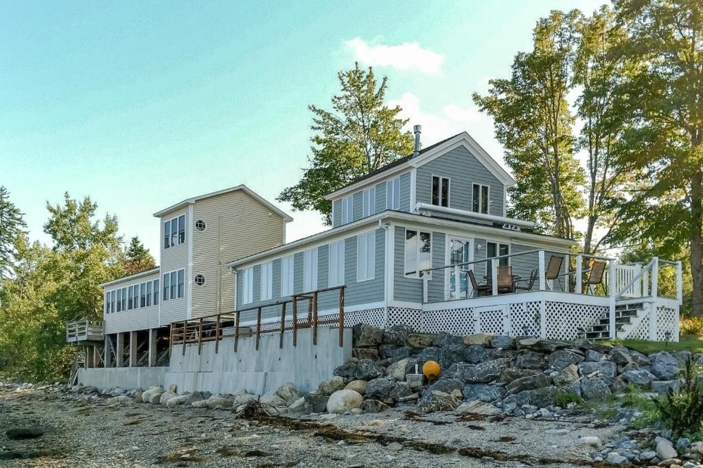 a large house on a hill with rocks at Dream Harbor House and Cottage in Surry