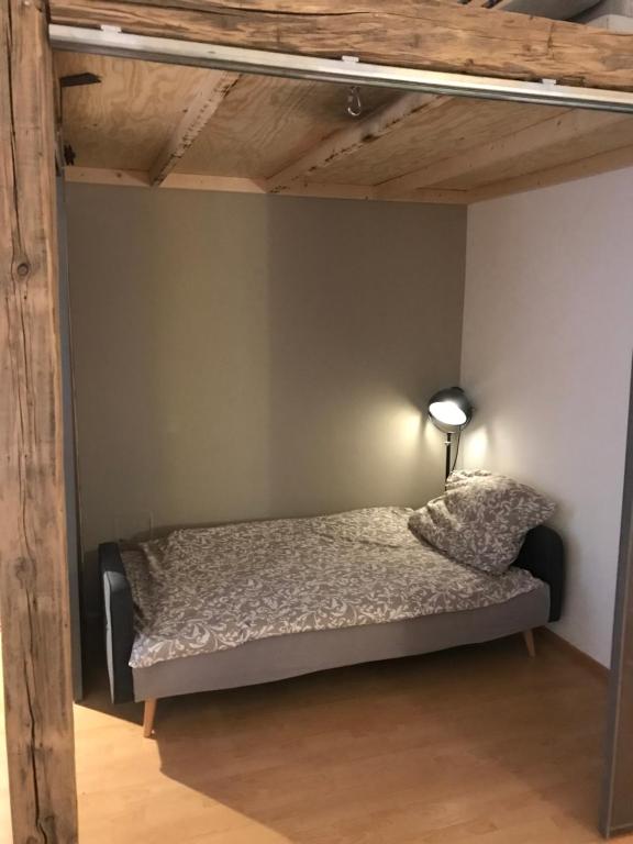 a bedroom with a bed with a lamp on it at Apartment 26 Eighty in Semmering