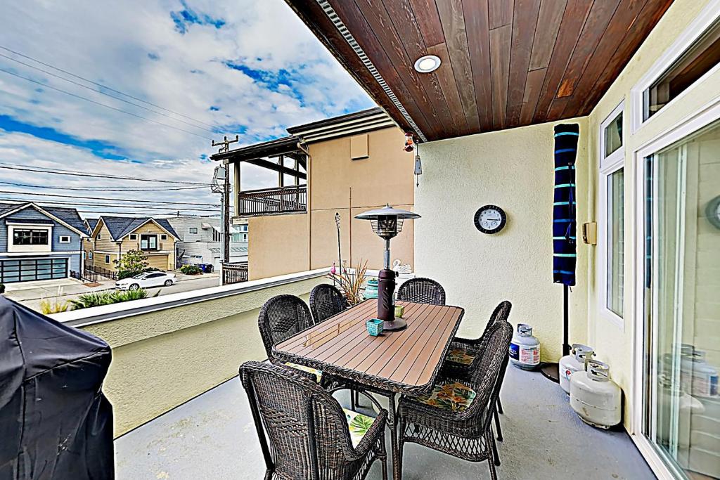 a patio with a table and chairs on a balcony at Alki Adventures in Seattle