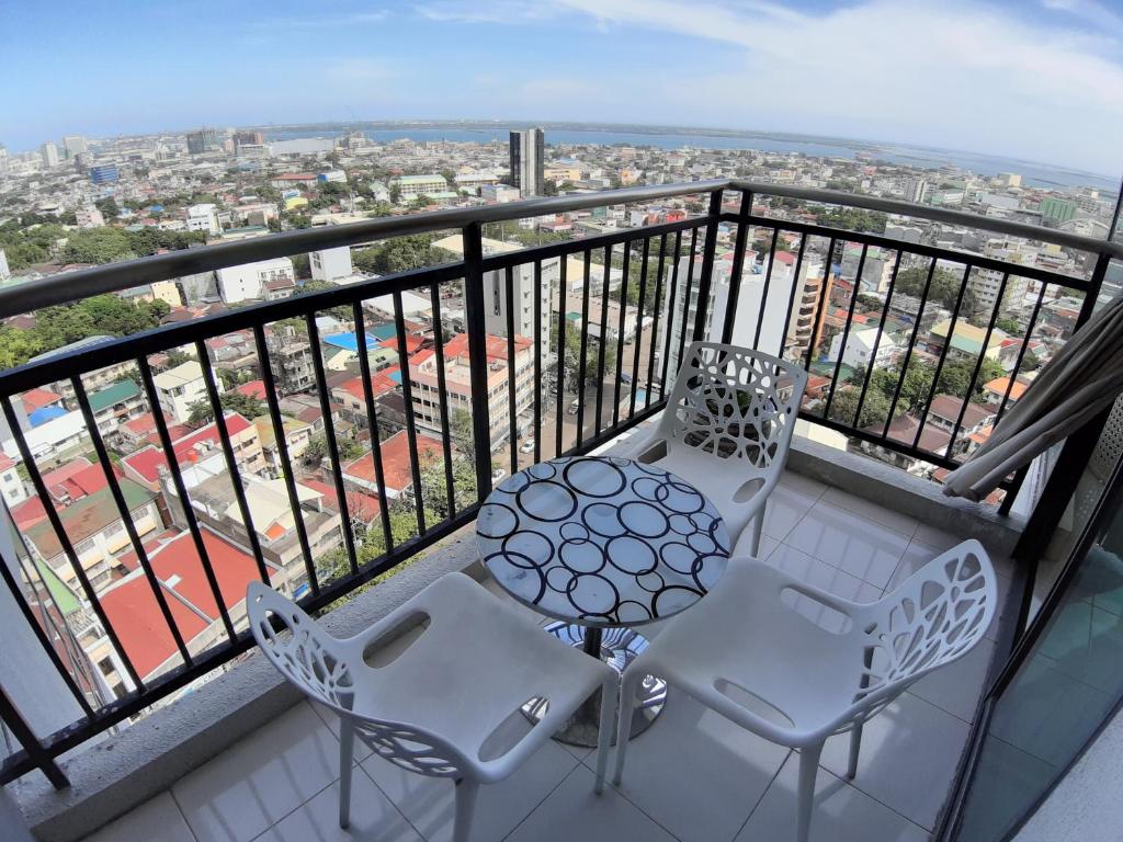a balcony with two chairs and a table at Cebu City Suites Ramos Tower by P&J in Cebu City