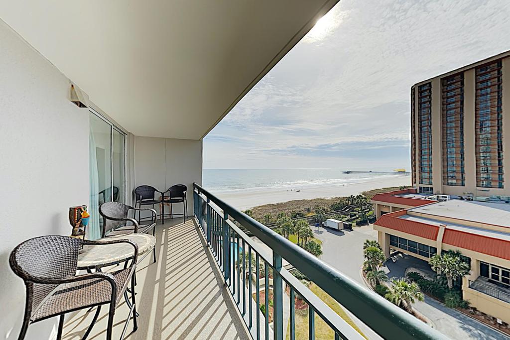 een balkon met stoelen en uitzicht op het strand bij Kingston Plantation Unit 706 in Myrtle Beach