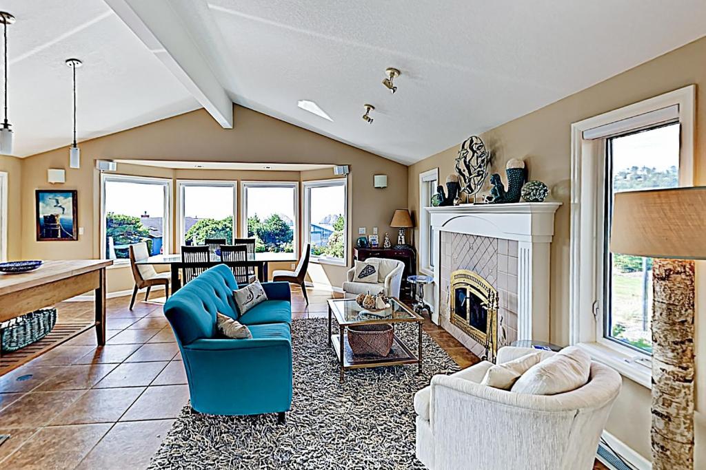 a living room with a blue couch and a fireplace at Firepit Lagoon in Oceanside