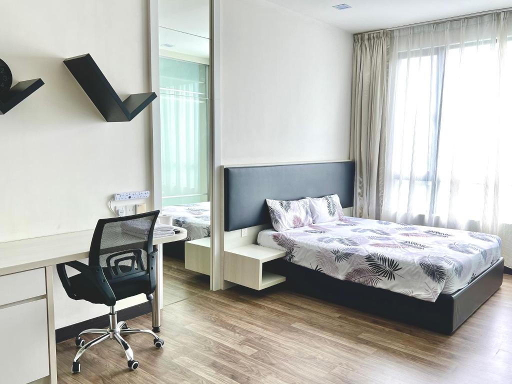 a bedroom with a bed and a desk and a chair at LANDMARK2 - GreenView, QuietSpace, BudgetStay, FreeParking, Near Kajang, SgLong, C180, Cheras in Kajang