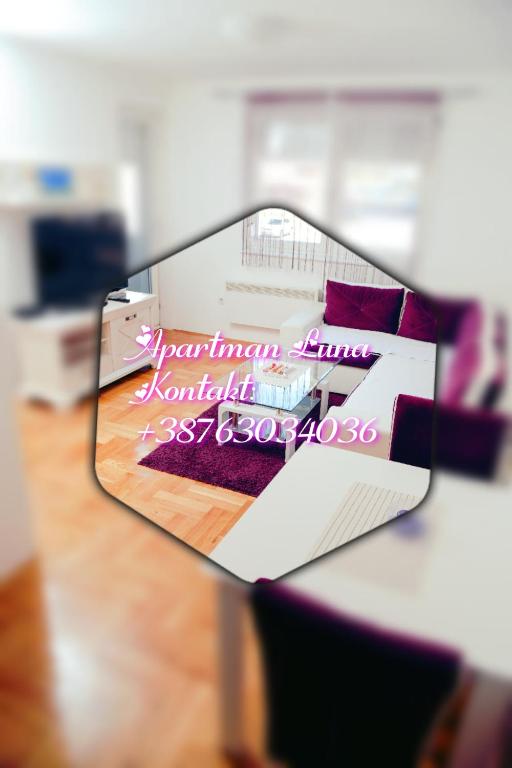 a mirror reflecting a picture of a room at Apartman Luna lukavica in Lukavica