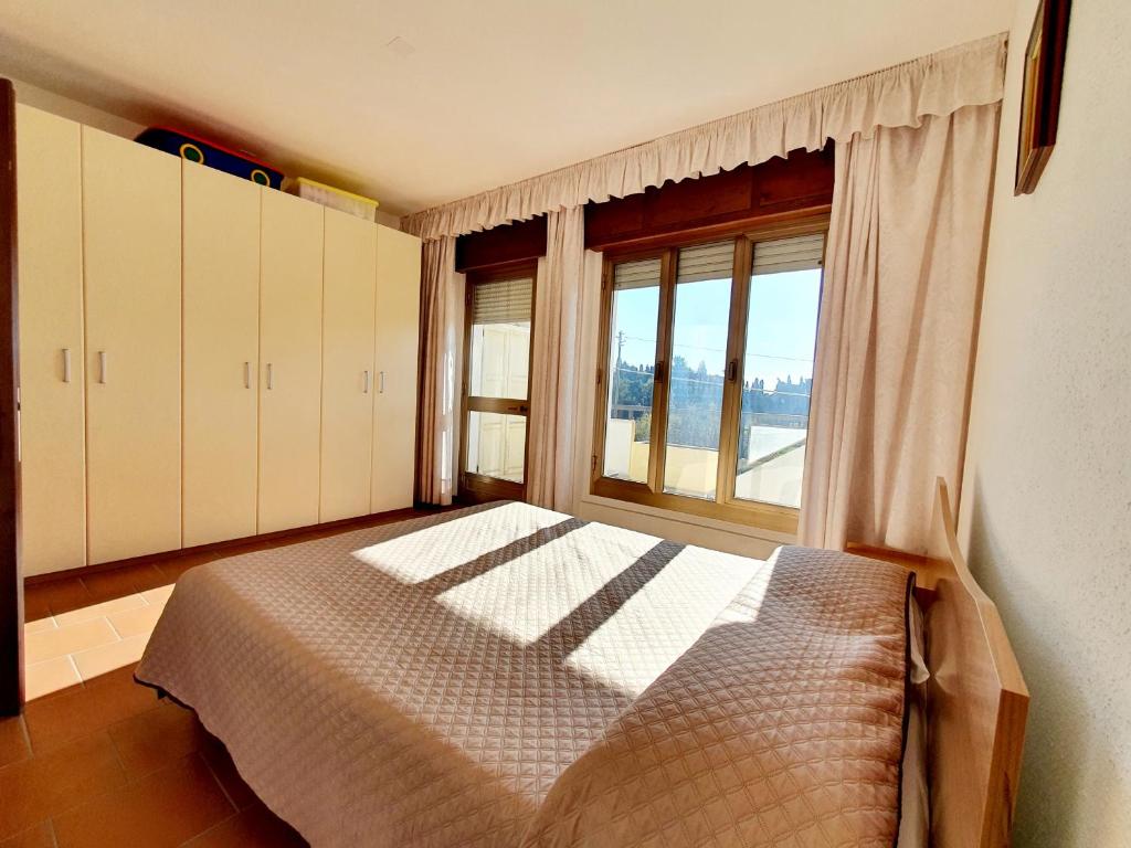 a bedroom with a bed and a large window at Marinaway - Appartamenti a 2 chilometri dal mare in Orosei