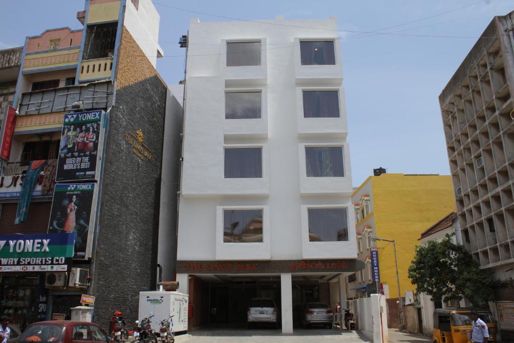 a white building on a city street with buildings at The Kings Park Residency in Chennai