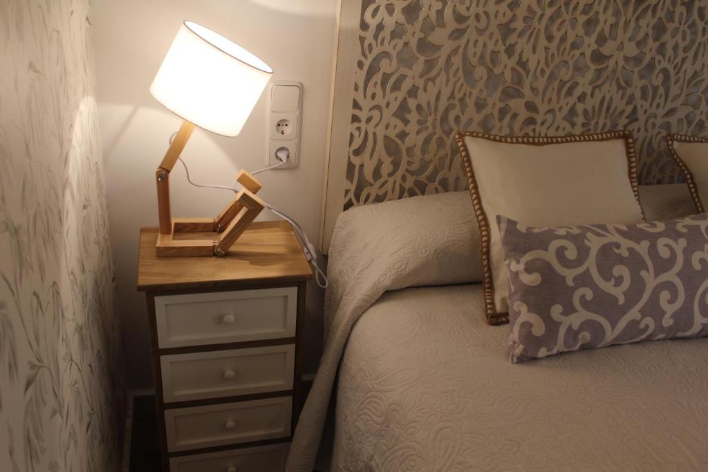 Cama o camas de una habitación en Apartamentos Oncemolinos con desayuno