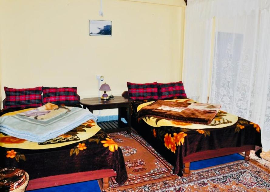 Postel nebo postele na pokoji v ubytování Dew Drop Homestay