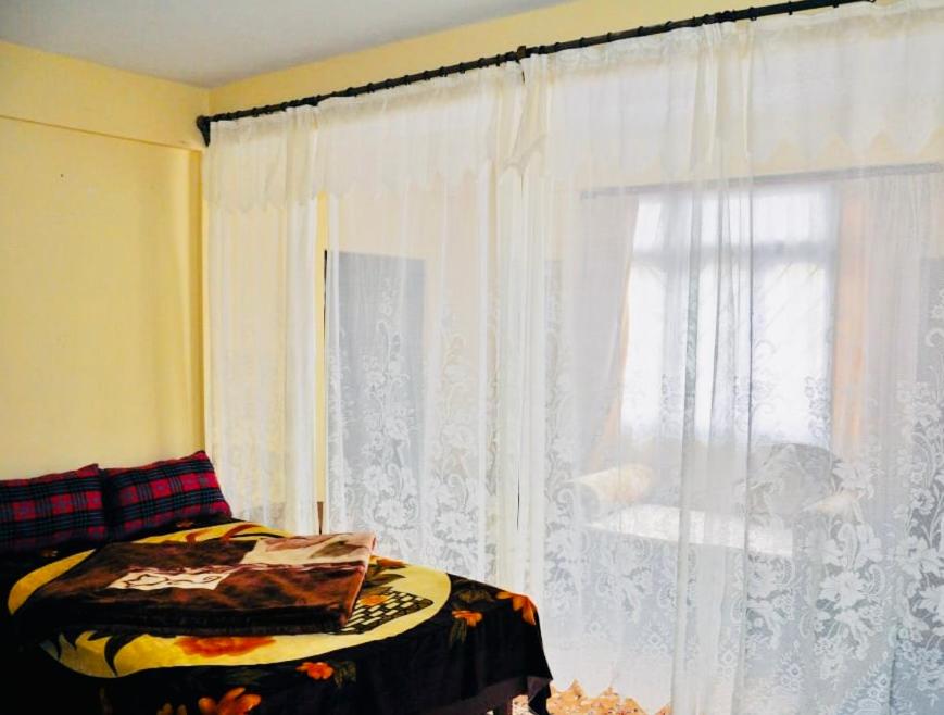 Postel nebo postele na pokoji v ubytování Dew Drop Homestay
