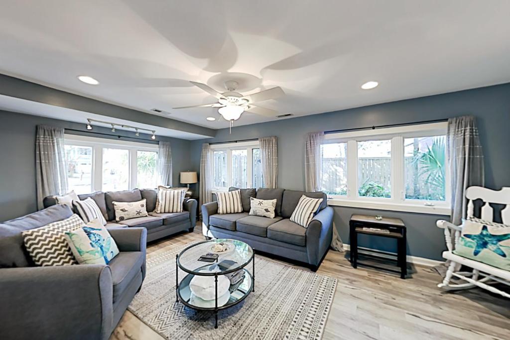 a living room with couches and a table at 30 22nd Ave in Isle of Palms