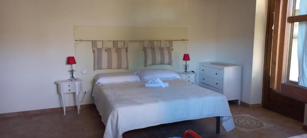 Postel nebo postele na pokoji v ubytování Agriturismo La Quiete