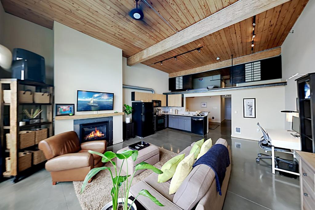 a living room with a couch and a fireplace at 19th Avenue Lofts Unit 213 in Seattle
