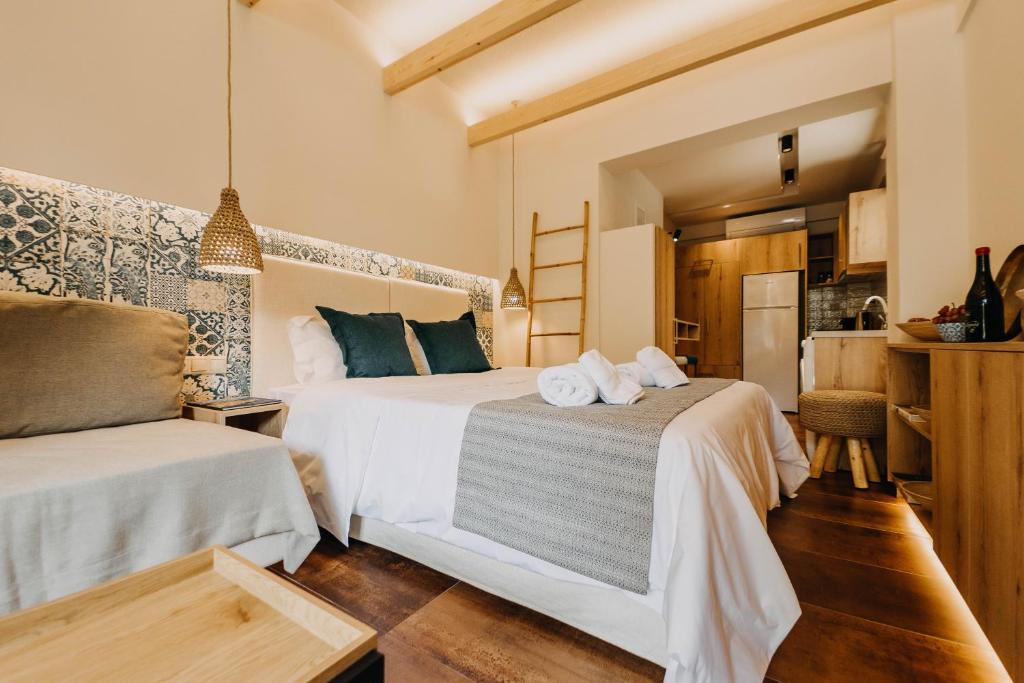 a hotel room with two beds and a kitchen at Loutraki Hidden Gem Ι in Loutraki
