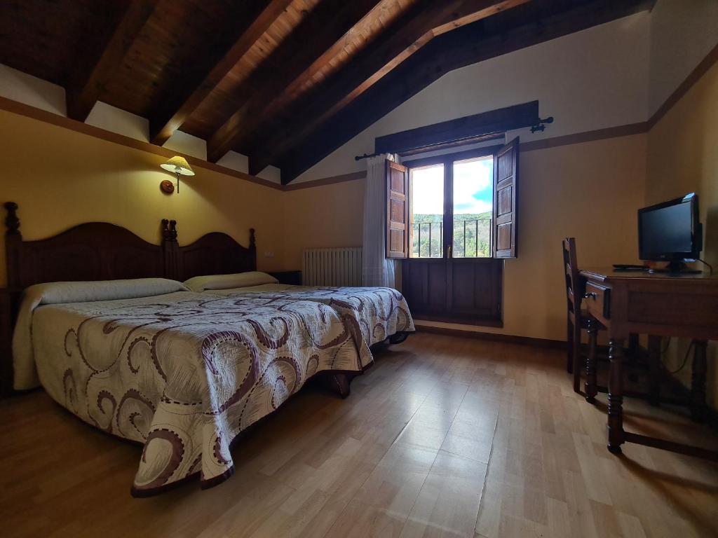 Postel nebo postele na pokoji v ubytování Hostal Las Nieves