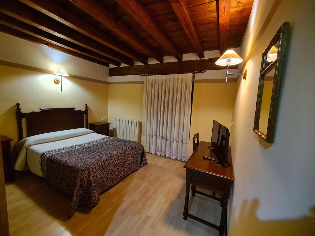 Postel nebo postele na pokoji v ubytování Hostal Las Nieves