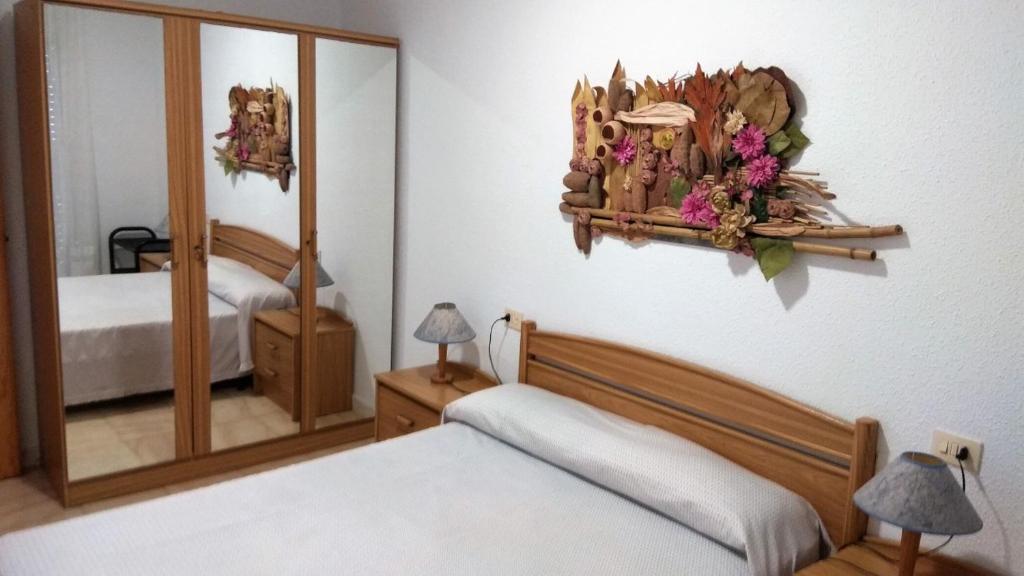 A bed or beds in a room at PEÑISMAR FiNCAS VAN CAMP