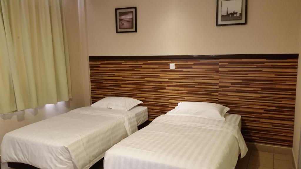 Postel nebo postele na pokoji v ubytování Hotel Sri Iskandar