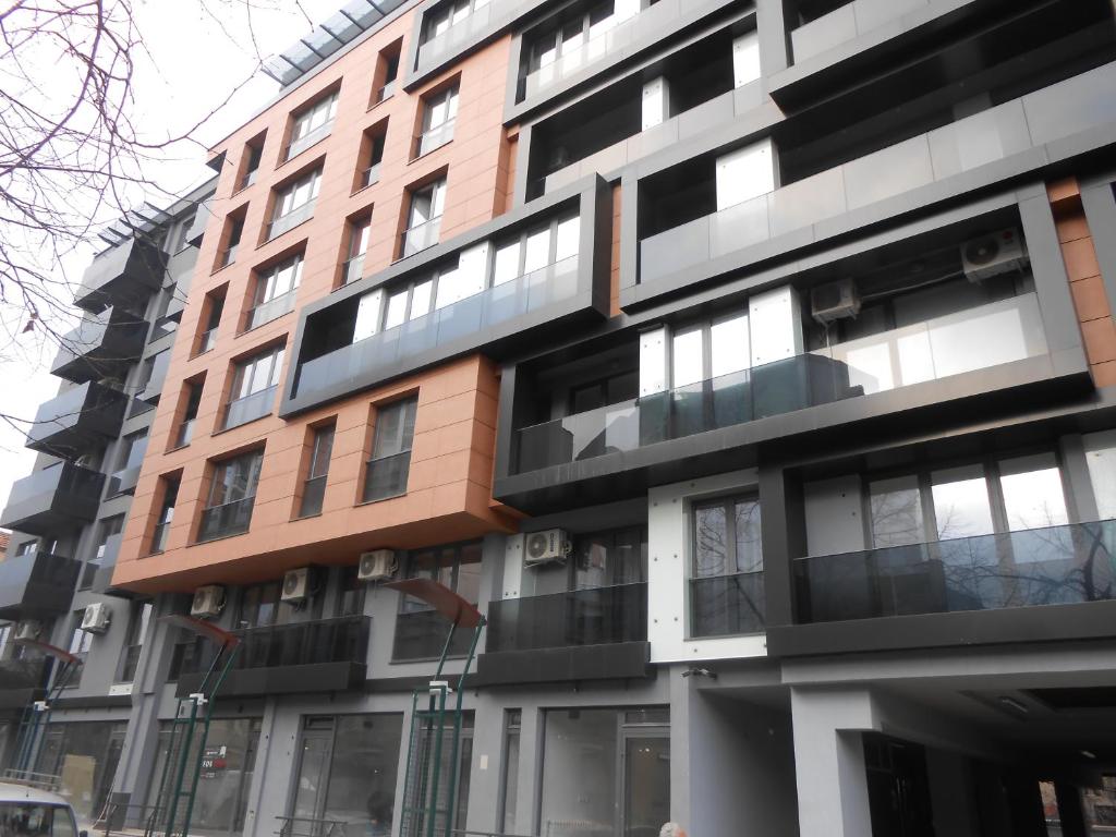 a tall building with many windows on a street at Apartments Kolevski in Skopje