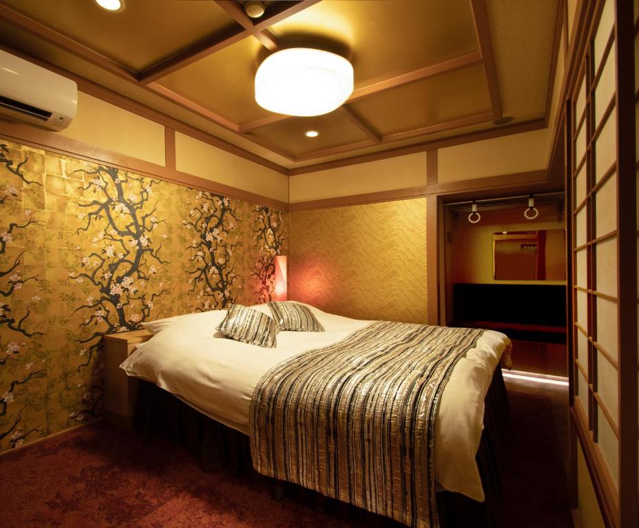 Postel nebo postele na pokoji v ubytování Hotel Benkyo Beya Amagasaki