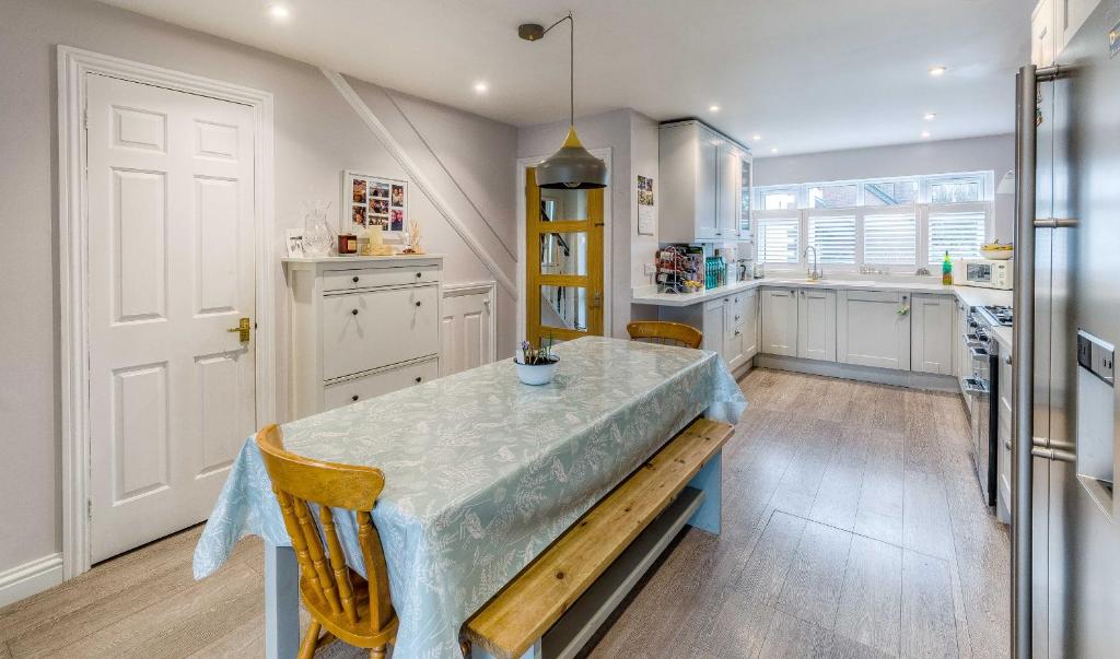 a kitchen with a table with a counter top at Stylish Townhouse with views of Arundel Cathedral in Arundel