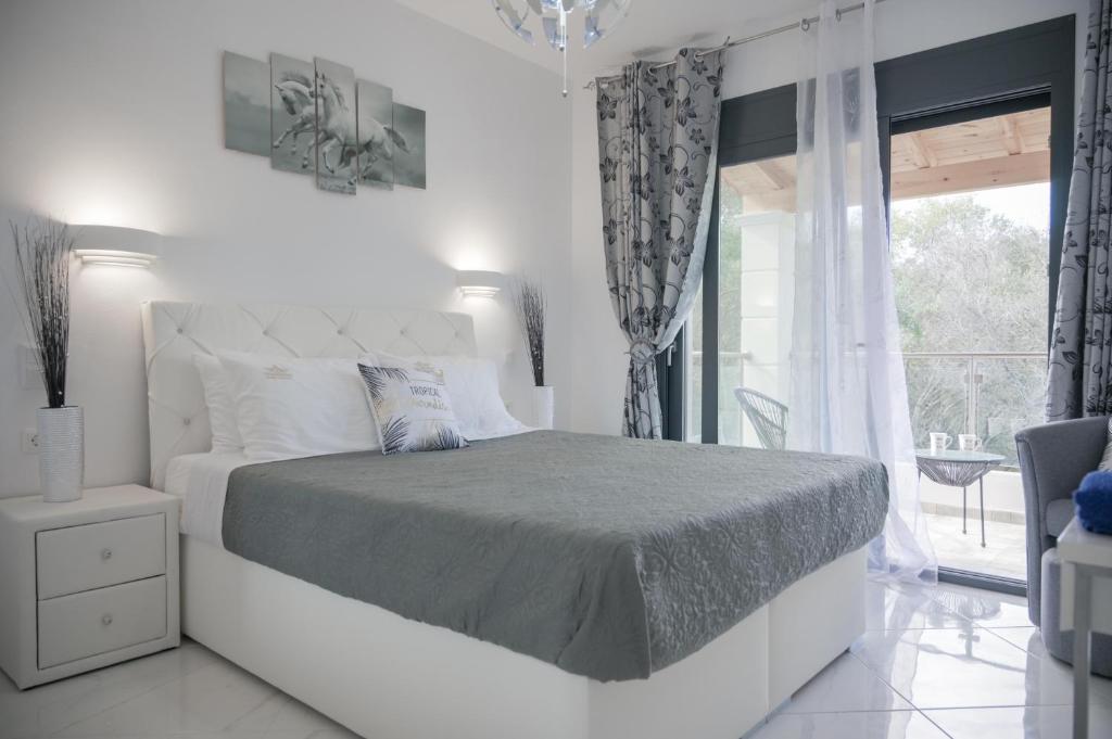 A bed or beds in a room at Diamond Luxury Villa Corfu 6 Bedroom Luxury Villa