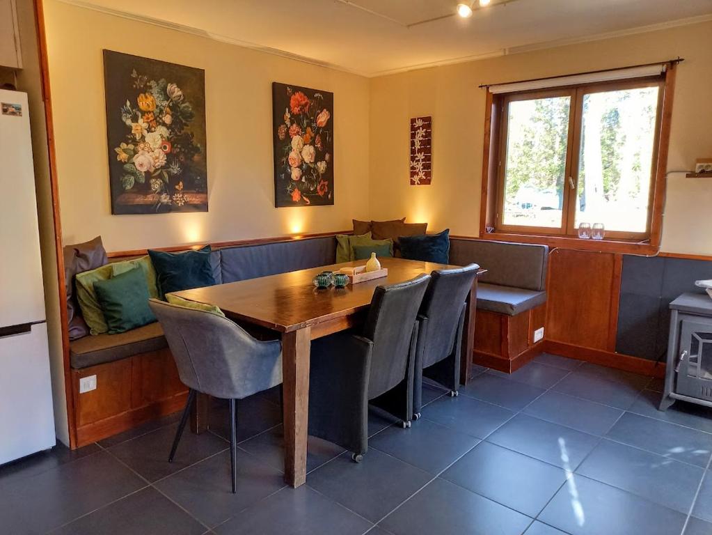 a dining room with a wooden table and chairs at Holiday home"Monsieur Nips" in Érezée