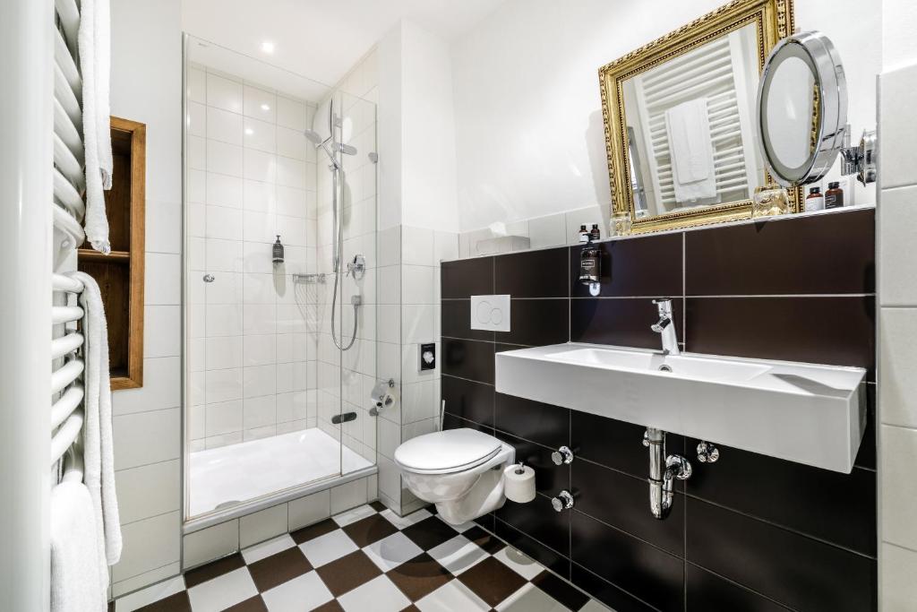 a bathroom with a sink and a toilet and a shower at Bohemian Hotel in Regensburg