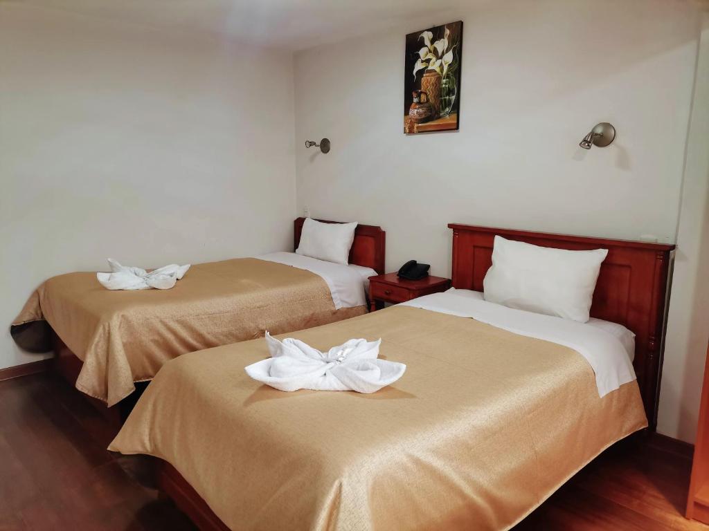 Postel nebo postele na pokoji v ubytování Hotel Urpi Cusco